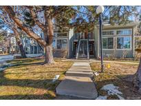 Charming townhome featuring a well-maintained lawn, mature tree, and inviting walkway at 4084 S Carson St # A, Aurora, CO 80014