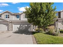 Two-story townhome with attached garage and landscaped front yard at 6005 Turnstone Pl, Castle Rock, CO 80104