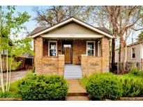 Charming brick home with a well-manicured front yard and inviting porch at 2731 S Logan St, Englewood, CO 80113
