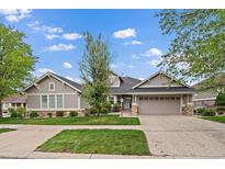 Charming single-story home with a well-manicured lawn, two-car garage, and beautiful stone accents at 7750 S Buchanan Way, Aurora, CO 80016