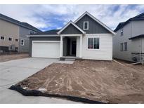 Charming single-Gathering home featuring a two-car garage and stylish gray and white color palette at 4316 Ridgewalk Pt, Arvada, CO 80007