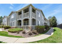 Inviting multi-level condo featuring private balconies and well-maintained landscaping in a residential neighborhood at 1404 Whitehall Dr # C, Longmont, CO 80504