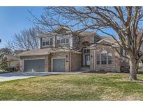 Charming two-story brick home featuring a three-car garage and well-manicured front lawn at 3343 W 109Th Cir, Westminster, CO 80031
