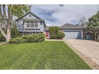 Charming two-story home with a well-manicured lawn and mature landscaping at 1758 S Ensenada St, Aurora, CO 80017