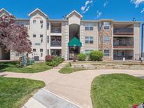 Inviting condominium complex featuring well-manicured lawns and attractive architectural details at 12348 W Dorado Pl # 204, Littleton, CO 80127