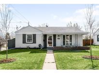 Charming single-story home with a well-manicured lawn and inviting front porch at 1380 Roslyn St, Denver, CO 80220