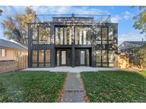 Modern two-story home with black trim, large windows, rooftop deck, and inviting landscaped front yard at 4225 N Navajo St, Denver, CO 80211