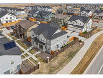 Beautiful two-story home with a gray exterior, well-manicured lawn, and fence in a Gathering-friendly neighborhood at 608 N Bersshine Ct, Watkins, CO 80137