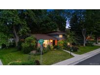 Charming two-story brick home with mature landscaping and a well-maintained front yard in a quiet neighborhood at 4634 W Tufts Cir, Denver, CO 80236