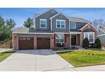 Beautiful two-story home featuring a brick and siding facade with a three-car garage at 762 Hughes Ln, Highlands Ranch, CO 80126