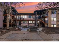 Apartment building with wood staircases and balconies on multiple floors at sunset at 875 S Quebec St # 21, Denver, CO 80247