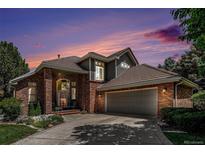 Beautiful home with brick and gray siding, a tile roof, and mature landscaping, perfect for curb appeal at 6500 W Mansfield Ave # 39, Denver, CO 80235