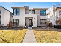 Striking two-story home with a modern facade and well-manicured front lawn in a residential neighborhood at 2255 S Monroe St, Denver, CO 80210