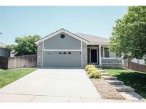 Charming home featuring a two-car garage and covered porch, perfect for suburban living at 18656 E Harvard Dr, Aurora, CO 80013