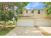Inviting townhome with a two-car garage and well-maintained front yard landscaping at 7977 S Kittredge St, Englewood, CO 80112