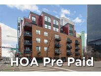 Brick apartment building in downtown with balconies and street-level retail and HOA Pre Paid Text Overlay at 1800 Lawrence St # 408, Denver, CO 80202