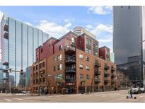 Brick building exterior with multiple balconies and city views at 1800 Lawrence St # 408, Denver, CO 80202