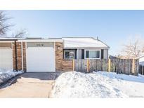 Brick ranch home with attached garage and fenced yard at 2030 Santana Dr, Castle Rock, CO 80104