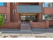 Building entrance with brick facade, glass doors, and 'Governor's Abbey' signage, providing a welcoming atmosphere at 534 E 7Th Ave # 206, Denver, CO 80203