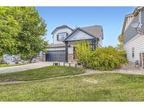 Charming two-story home featuring a two-car garage, stone accents, and a well-manicured front yard at 9544 Longford Way, Parker, CO 80134