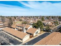 Expansive aerial view of a residential community with mature trees and well-maintained streets under a blue sky at 3657 S Laredo St # E, Aurora, CO 80013