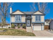 Charming two-story home featuring a well-manicured lawn, neutral siding, and an attached one car garage at 11437 W 103Rd Ave, Broomfield, CO 80021