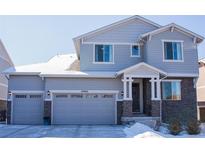 Charming two-story home with stone accents, a two-car garage, and a welcoming front entrance at 26960 E Costilla Dr, Aurora, CO 80016