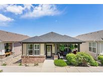Charming single-story home featuring a cozy front porch and well-maintained landscaping at 19780 W 57Th Ln, Golden, CO 80403