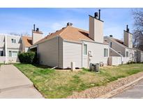 A charming townhouse featuring neutral siding, brown roofing, chimney and well-kept lawn in a suburban setting at 13635 E Yale Ave # D, Aurora, CO 80014