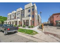Modern townhome exterior featuring brick accents, neutral siding, and manicured landscaping, offering curb appeal at 7035 E 38Th Ave # 4, Denver, CO 80207