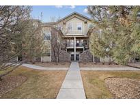 Inviting multi-story condo featuring stone accents and well-maintained landscaping at 5800 Tower Rd # 908, Denver, CO 80249