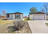 Charming single Gathering home featuring a detached garage and classic design elements at 7120 Utica St, Westminster, CO 80030