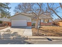 Charming single-Gathering home with a well-manicured front yard, attached garage, and brick accents at 12070 E Arizona Ave, Aurora, CO 80012