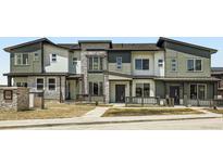 Modern townhomes with stone and siding exteriors, and welcoming front porches create charming curb appeal at 14578 W 90Th Ln # B, Arvada, CO 80005