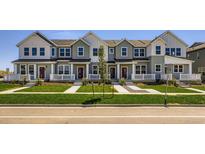 Charming townhomes featuring craftsman-style architecture, manicured lawns, and inviting front porches at 742 N Bently St, Watkins, CO 80137