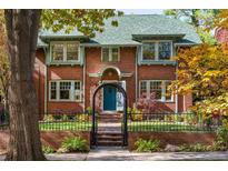 Charming brick home with a well-manicured front yard and inviting entrance at 815 Gaylord St, Denver, CO 80206