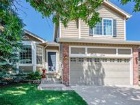 Inviting two-story home featuring a well-maintained lawn and a two-car garage at 1234 Riddlewood Ln, Highlands Ranch, CO 80129