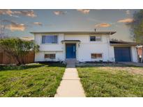 Charming two-story home with a lush front yard and a walkway leading to the front door at 846 E 114Th Pl, Northglenn, CO 80233