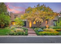 Charming home featuring professionally landscaped grounds and an inviting brick walkway leading to the front door at 9 Polo Field Ln, Denver, CO 80209