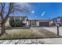 Charming two-story home featuring a well-maintained lawn and attached two car garage at 1567 S Sedalia St, Aurora, CO 80017