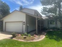 Charming home featuring a two-car garage, manicured lawn, and inviting curb appeal at 6213 S Galena Way, Englewood, CO 80111