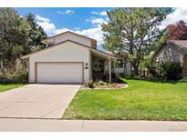 Charming two-story home with a well-maintained lawn and a two-car garage at 6213 S Galena Way, Englewood, CO 80111