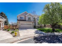 Charming two-story home featuring stone accents, a well-manicured lawn, and a two-car garage at 12646 S Dove Creek Way, Parker, CO 80134