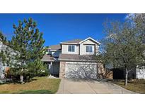Charming two-story home with attached garage, landscaped lawn, and lovely trees at 5956 S Winnipeg St, Aurora, CO 80015