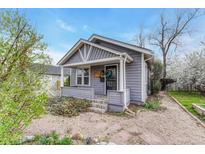 Charming home featuring a classic covered front porch with a cozy and well-kept front yard landscape at 1920 S Downing St, Denver, CO 80210