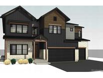 Charming two-story home with stone accents, and a two-car garage showcasing a modern architectural style at 933 Saint Andrews Ln, Louisville, CO 80027