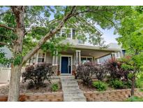 Charming two-story home with a welcoming porch and well-maintained landscaping at 13025 Umatilla Ct, Denver, CO 80234