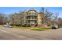 Charming multi-story condo building featuring balconies, brick accents, and lush landscaping at 1705 Gaylord St # 201, Denver, CO 80206