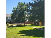 Community playground with mature trees and green space, perfect for outdoor activities at 970 S Peoria St, Aurora, CO 80012