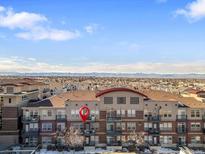 Aerial view of a condo building with mountain views in the background at 10184 Park Meadows Dr # 1213, Lone Tree, CO 80124